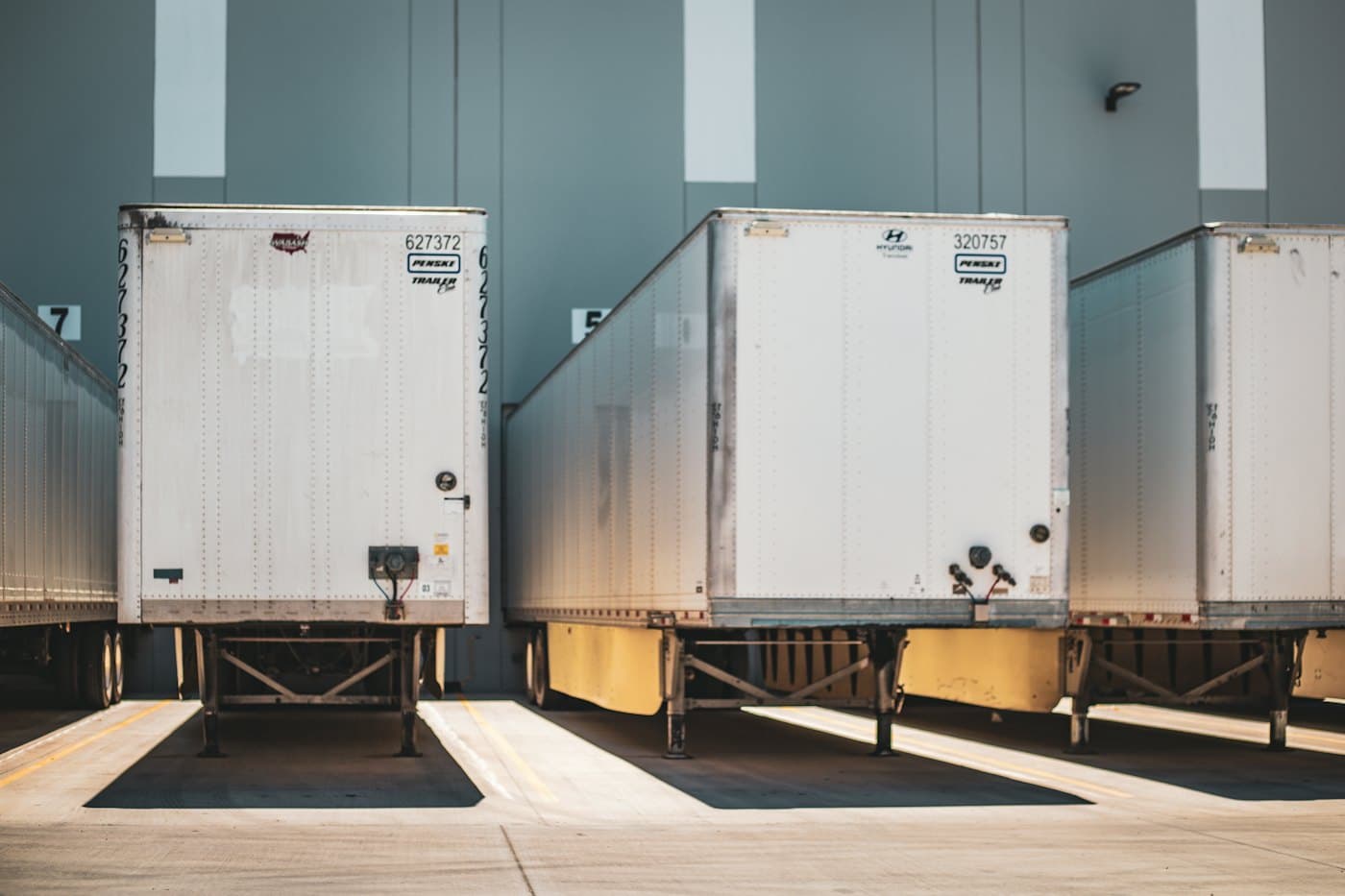 Trailers backed into the dock doors of a warehouse