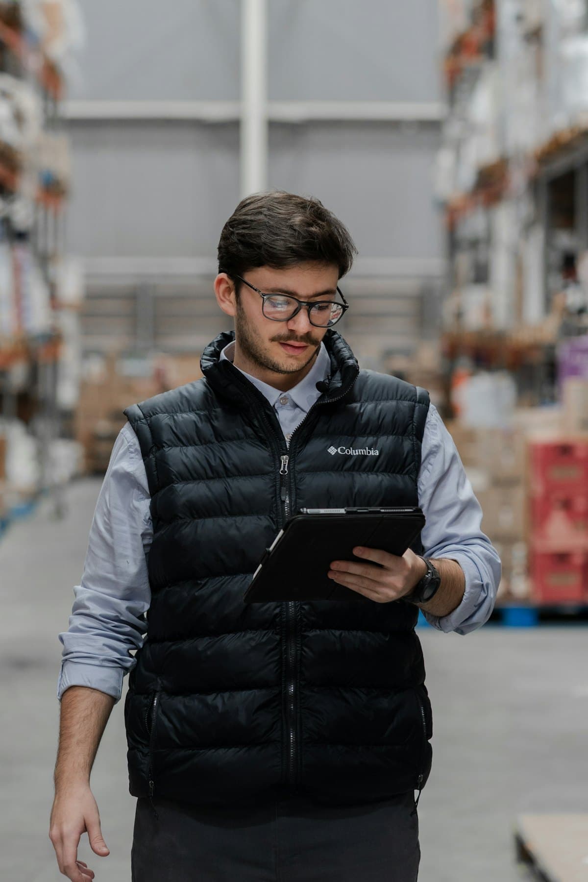 Receiver in the warehouse checking in a delivery on a tablet